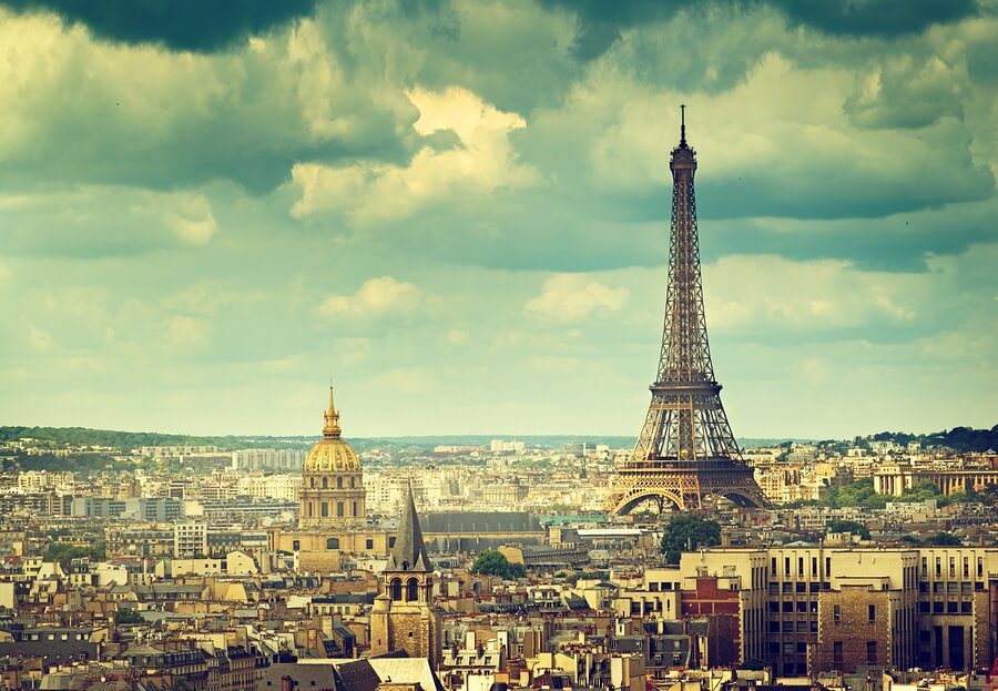 Visit the Eiffel tower on a Jewish heritage tour of France. The Eiffel tower and the Paris sky line on a yellow sky day.